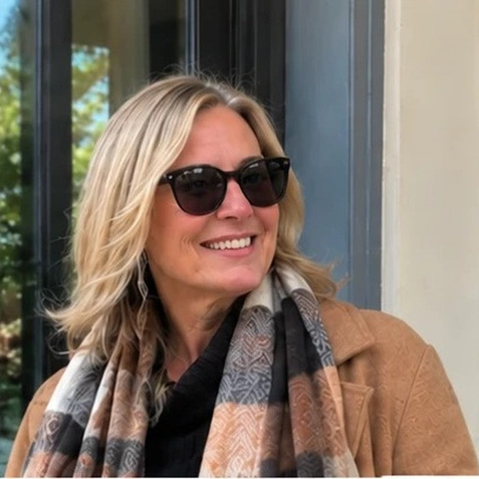 Customer in a camel coat and plaid scarf